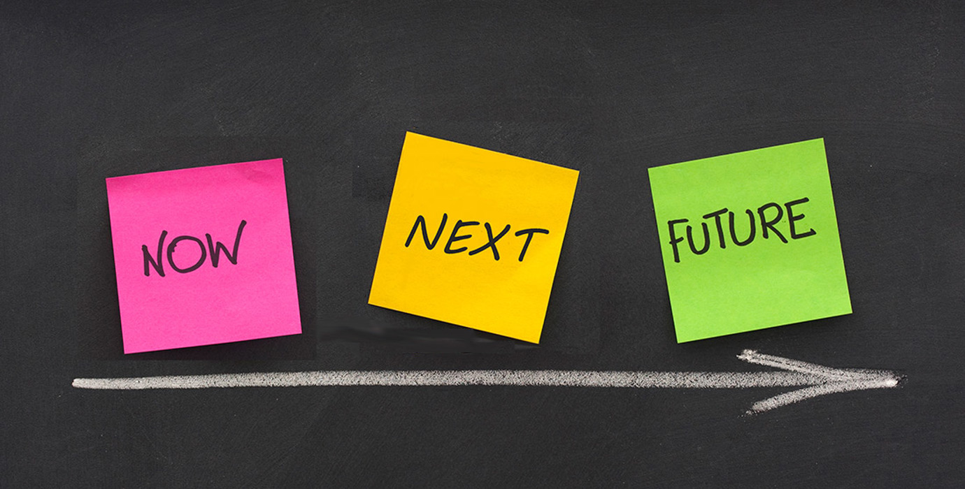 "NOW," "NEXT," and "FUTURE" written on sticky notes against with an arrow pointing toward "FUTURE"