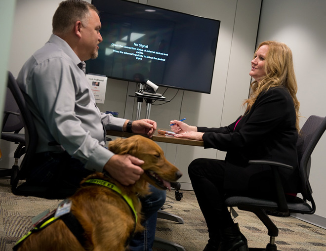 Person with service dog meeting in a board room